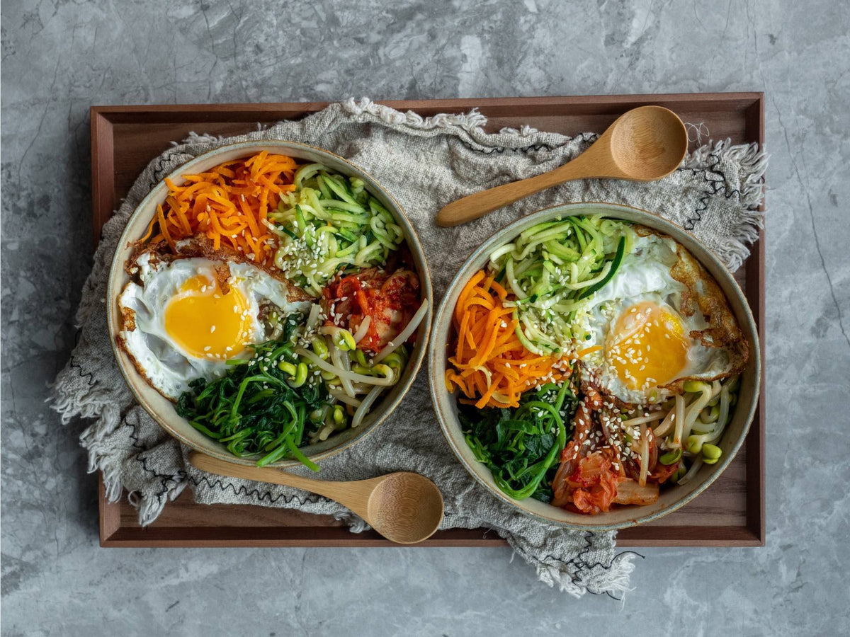 A bowl of bibimbap with vegetables and egg